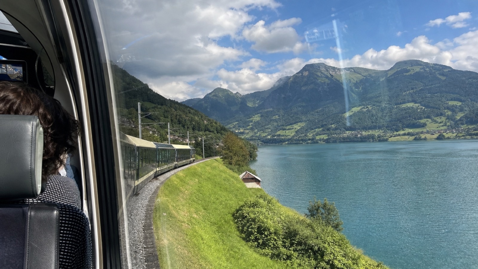 A summer lake view from a Swiss panoramic train window