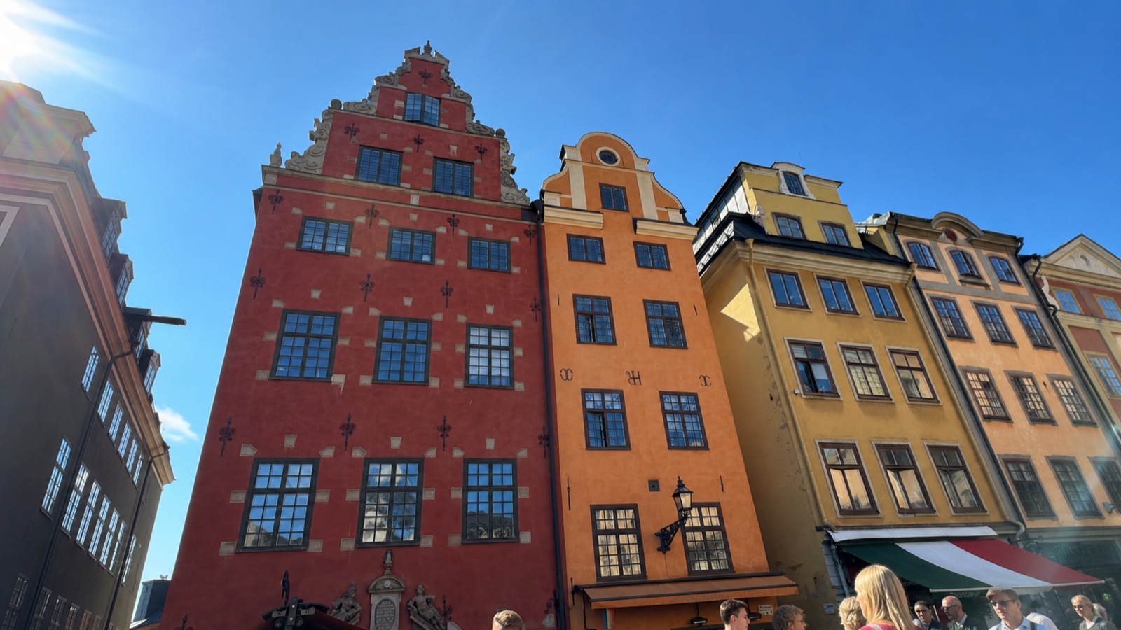 Colorful facades in Stockholm's Gamla Stan under a June-blue sky