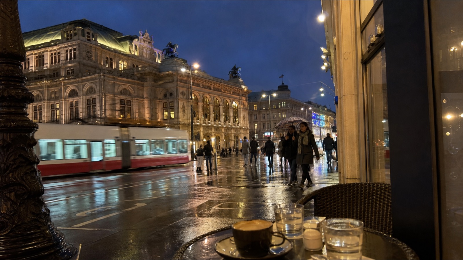 A rainy December Vienna street seen from a coffee-house table